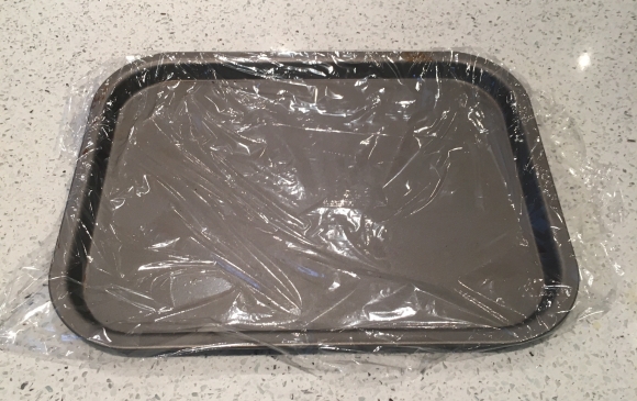Baking sheet lined with cling film